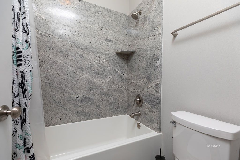 1030 Arroyo Street Ridgecrest, CA 93555 - Photo 30 of 49 a bathroom with a bathtub and a toilet