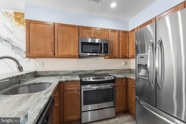 a kitchen with a sink stove and refrigerator