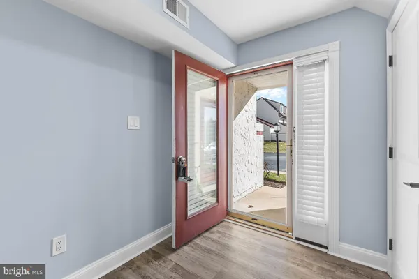 a view of hallway with bathroom and glass door