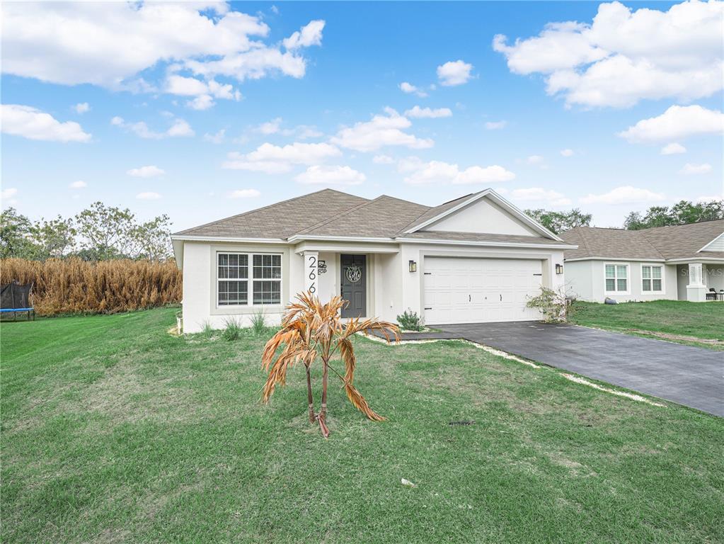 266 South Lake Avenue Frostproof, FL 33843 - Photo 2 of 42 a front view of a house with a yard