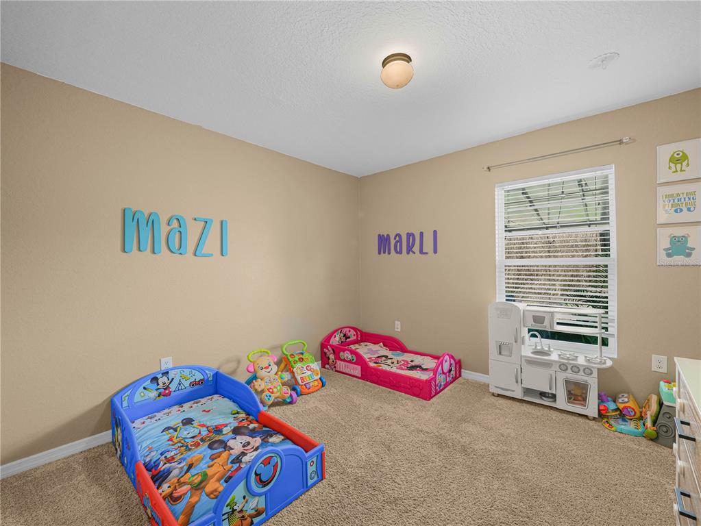 266 South Lake Avenue Frostproof, FL 33843 - Photo 23 of 42 a bedroom with a bed and a chandelier