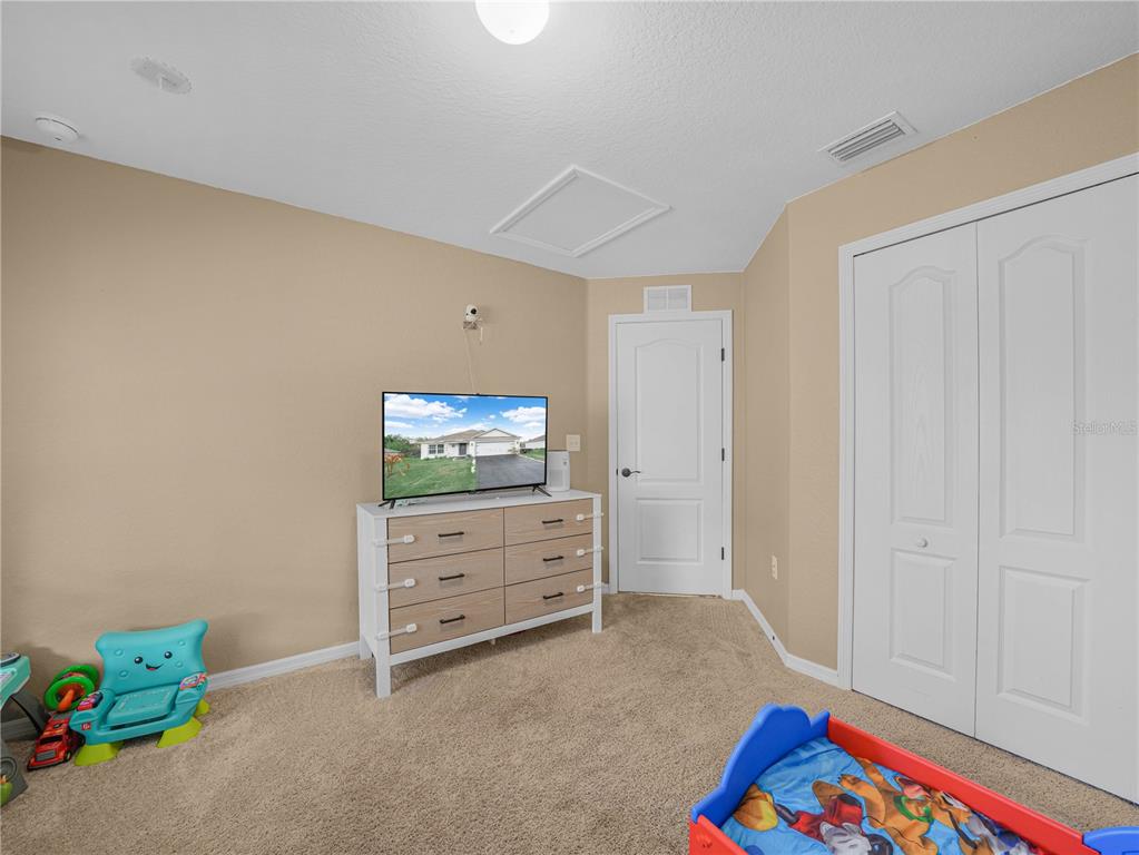 266 South Lake Avenue Frostproof, FL 33843 - Photo 24 of 42 a room with furniture and a flat screen tv