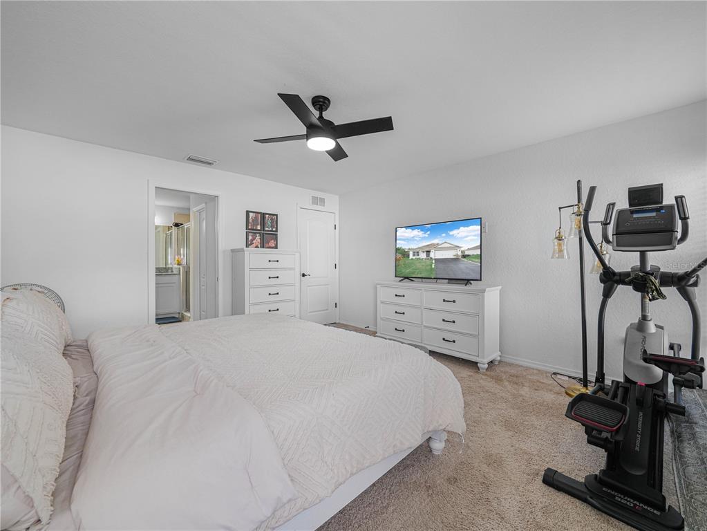 266 South Lake Avenue Frostproof, FL 33843 - Photo 25 of 42 a bedroom with a bed and a flat screen tv