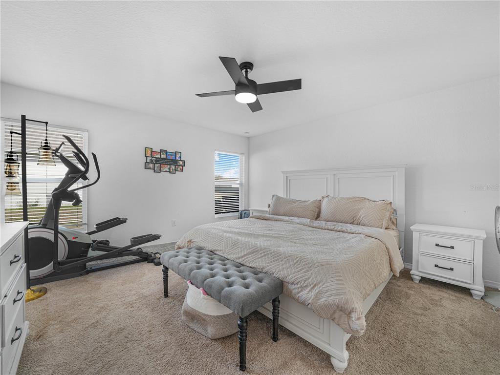 266 South Lake Avenue Frostproof, FL 33843 - Photo 26 of 42 a bedroom with a bed and a ceiling fan