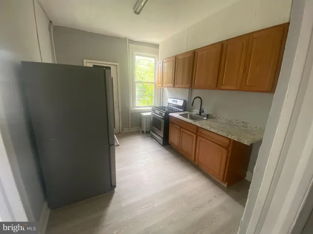 a kitchen with a refrigerator and a sink