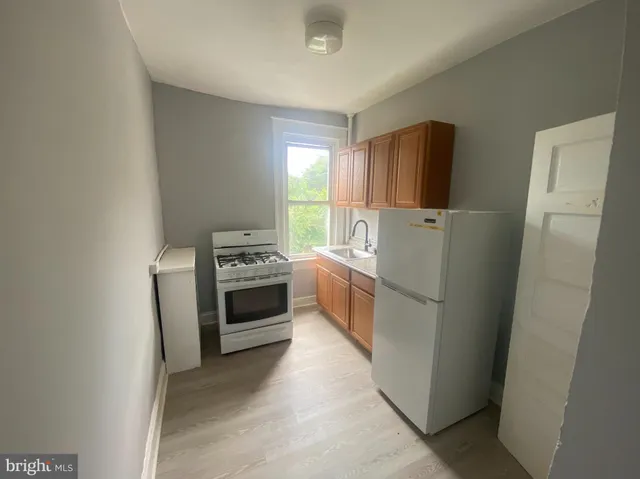 a kitchen with a refrigerator a stove a washer dryer and a washer dryer