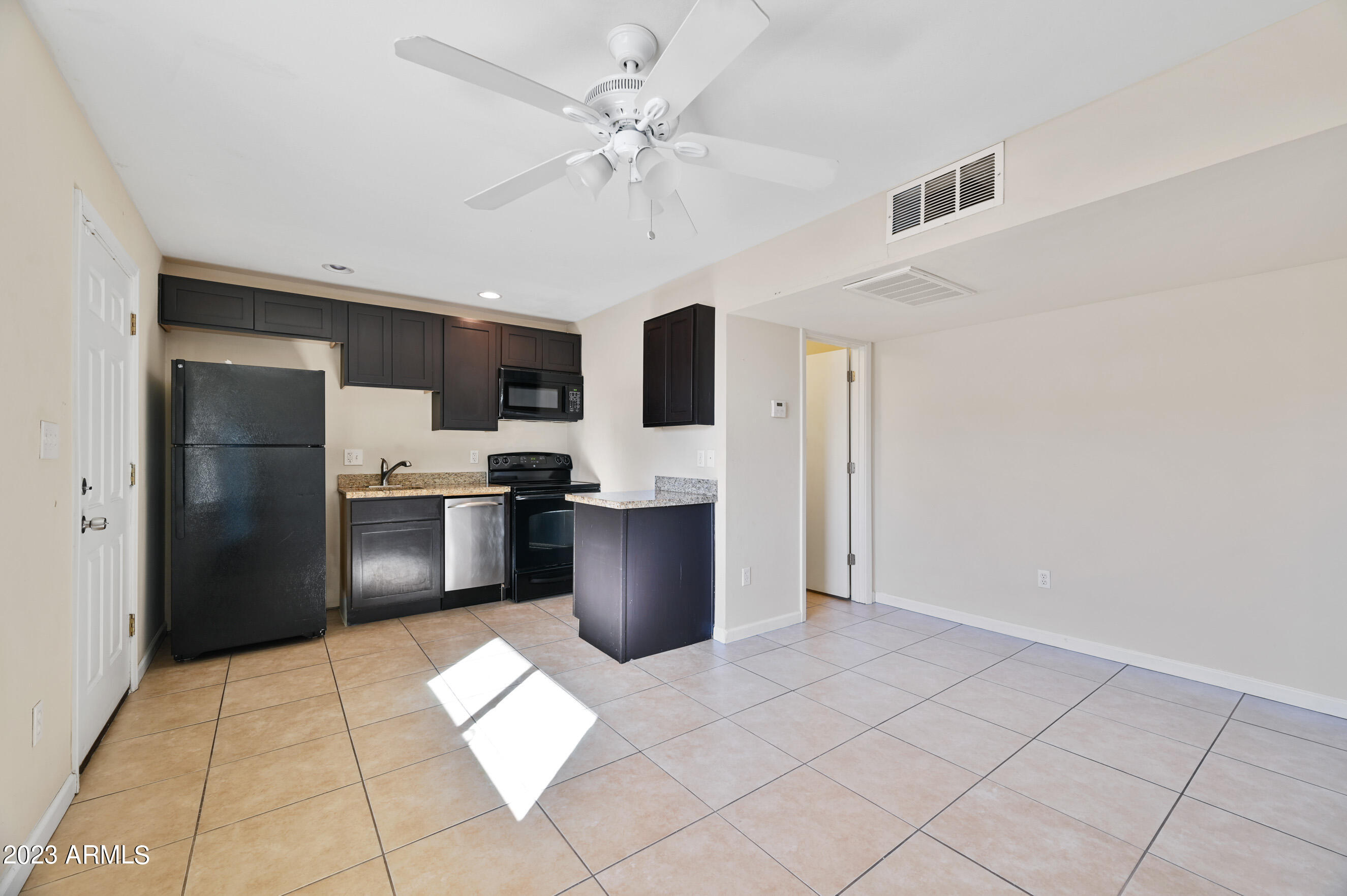 3949 East Earll Drive, Unit 4 Phoenix, AZ 85018 - Photo 4 of 11 a kitchen with stainless steel appliances a refrigerator and a stove top oven