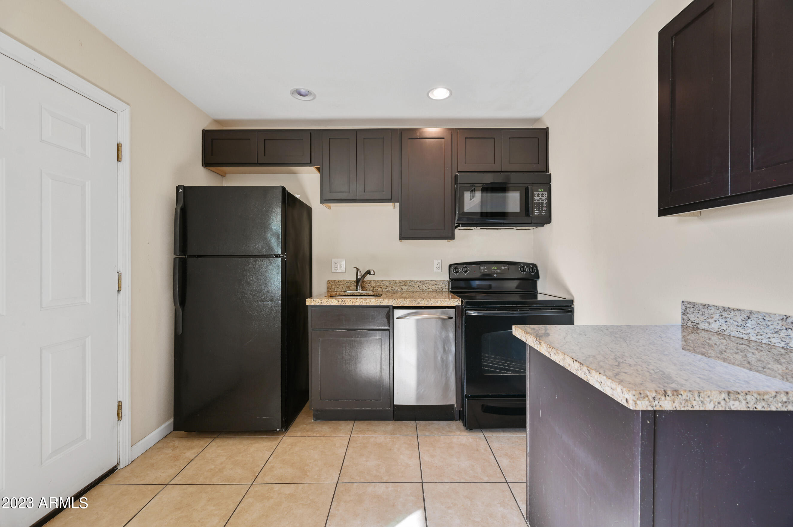 3949 East Earll Drive, Unit 4 Phoenix, AZ 85018 - Photo 6 of 11 a kitchen with a refrigerator and a stove top oven