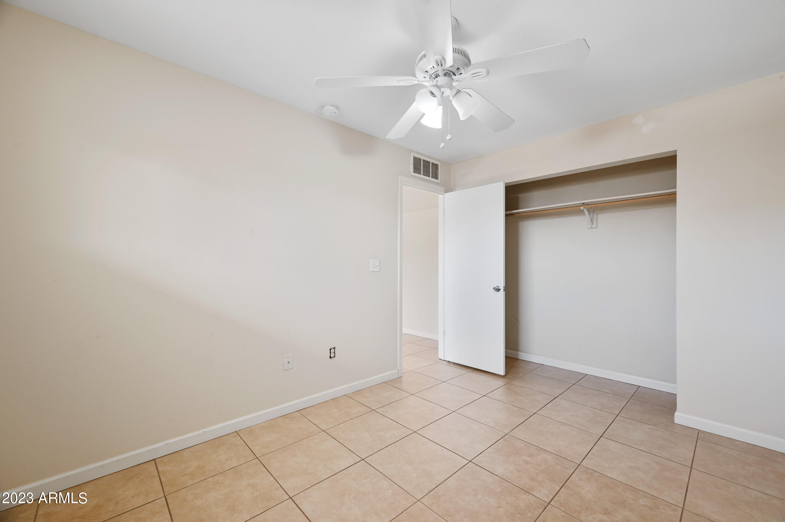 3949 East Earll Drive, Unit 4 Phoenix, AZ 85018 - Photo 10 of 11 an empty room with a ceiling fan