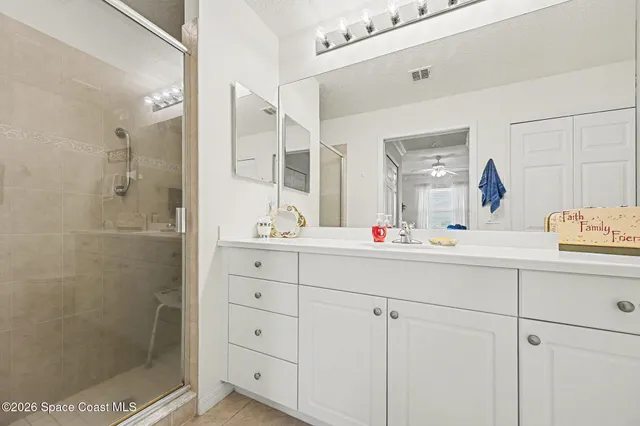 a bathroom with a shower sink and mirror