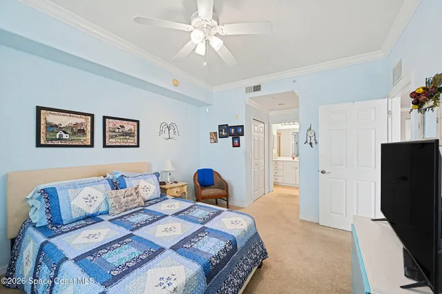 a bedroom with furniture and a flat screen tv