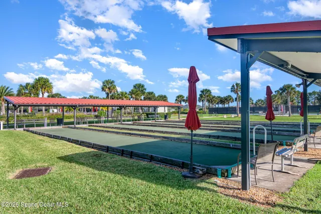 a view of swimming pool with outdoor seating and lake