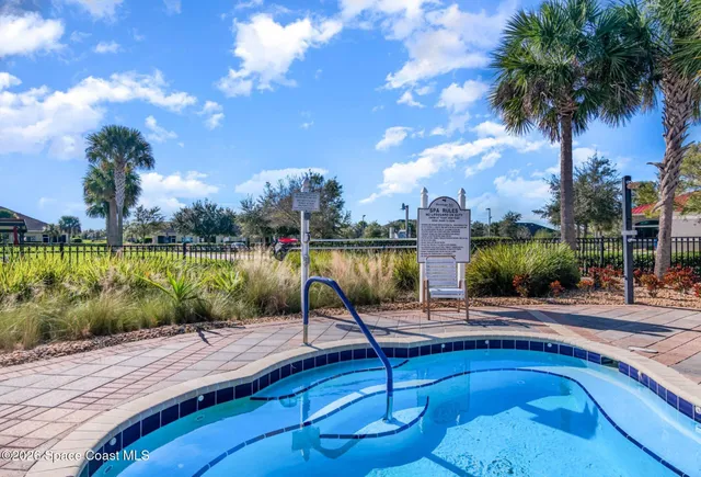 a view of swimming pool with seating space and barbeque oven