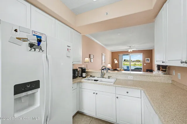 a kitchen with a sink cabinets and window