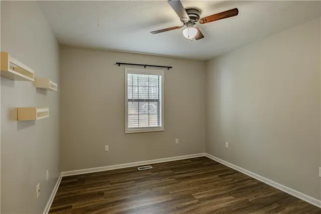 a view of an empty room with wooden floor