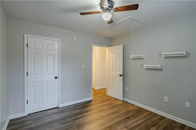 a bathroom with a granite countertop toilet sink and mirror