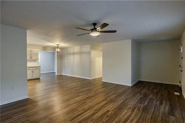 a kitchen with stainless steel appliances granite countertop a sink cabinets and wooden floor