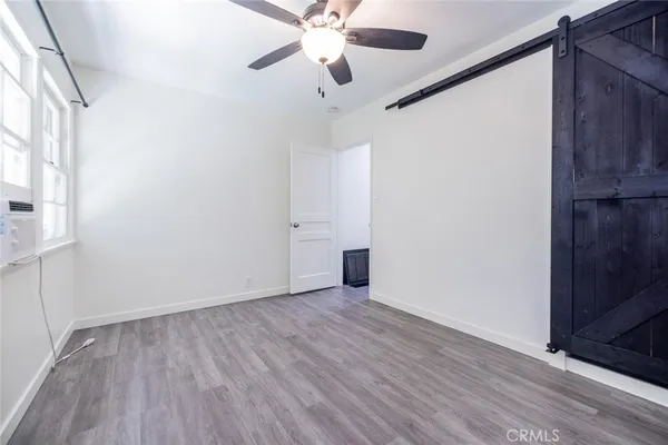 a view of an empty room with wooden floor