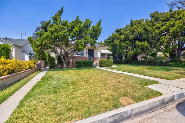 a view of house with yard and green space