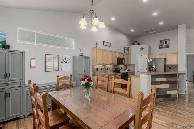 a large kitchen with kitchen island a table and chairs in it