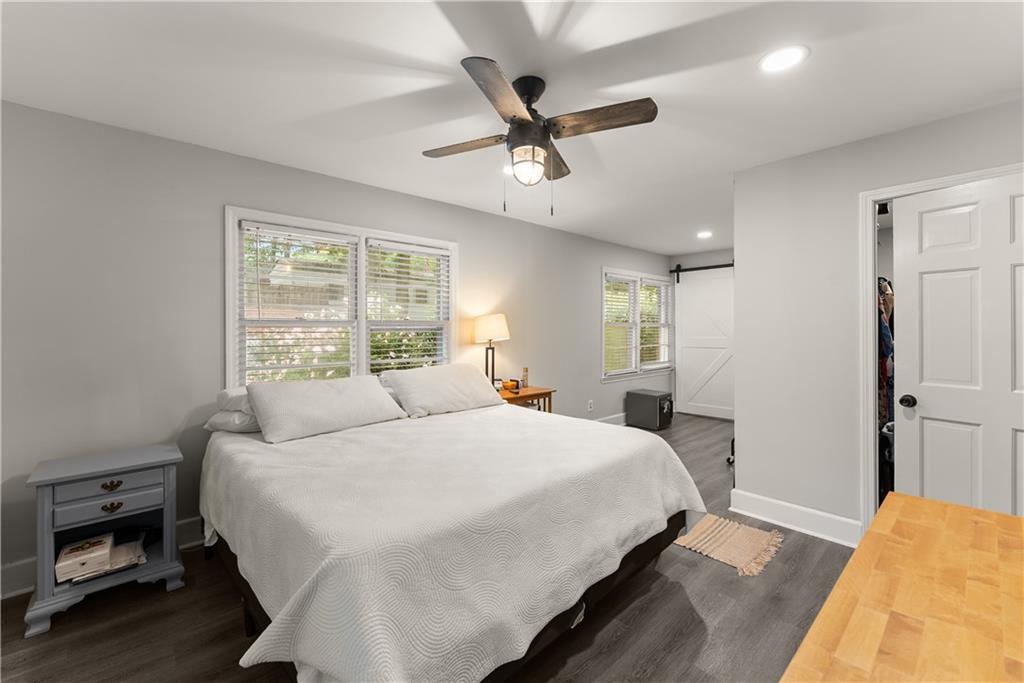 5907 Main Street Lula, GA 30554 - Photo 28 of 60 a bedroom with a large bed and a chandelier