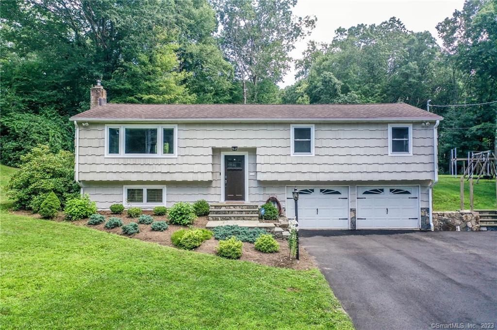 12 Jeremiah Road Newtown, CT 06482 - Photo 1 of 1 a front view of a house with a yard and a garage
