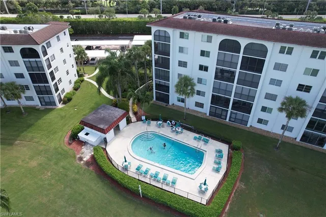 an aerial view of a house with a yard lake and ocean view