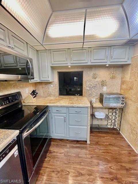 37 High Point Circle East, Unit 209 Naples, FL 34103 - Photo 17 of 20 a kitchen with stainless steel appliances a stove and a microwave