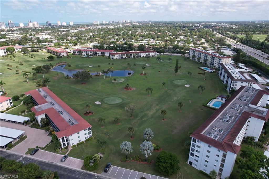 37 High Point Circle East, Unit 209 Naples, FL 34103 - Photo 19 of 20 an aerial view of a house with a yard