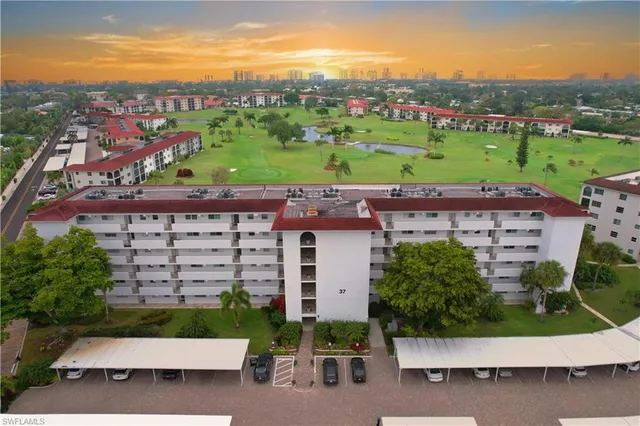 a view of a house with a yard and potted plants