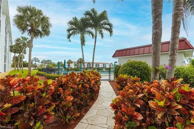 a bed room with a bed a television and a large window