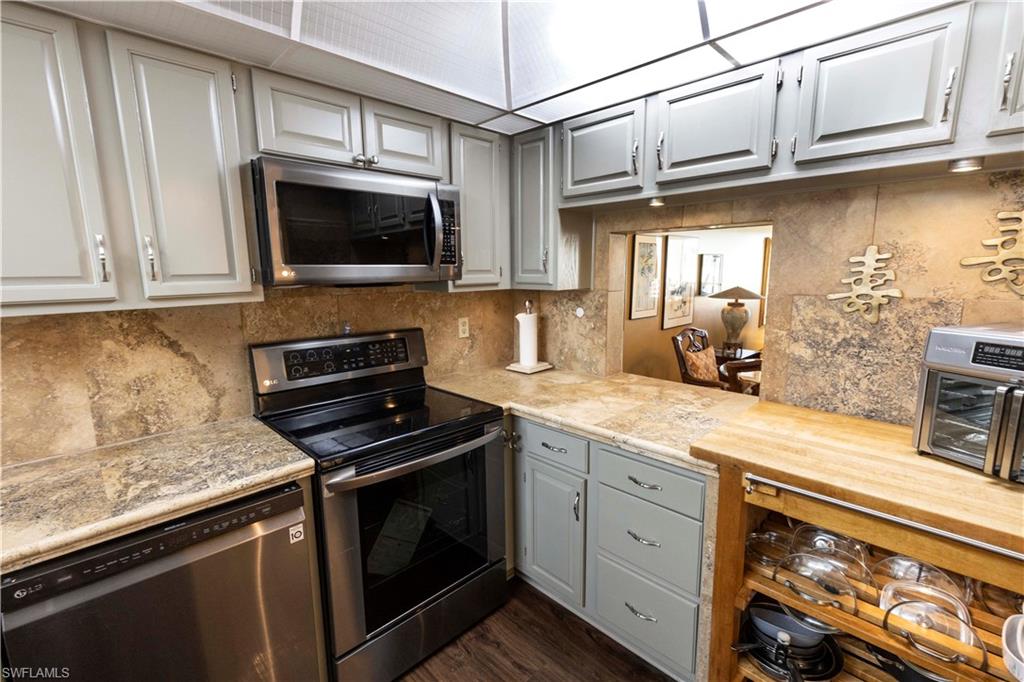 37 High Point Circle East, Unit 209 Naples, FL 34103 - Photo 10 of 20 a kitchen with stainless steel appliances granite countertop a stove microwave and sink