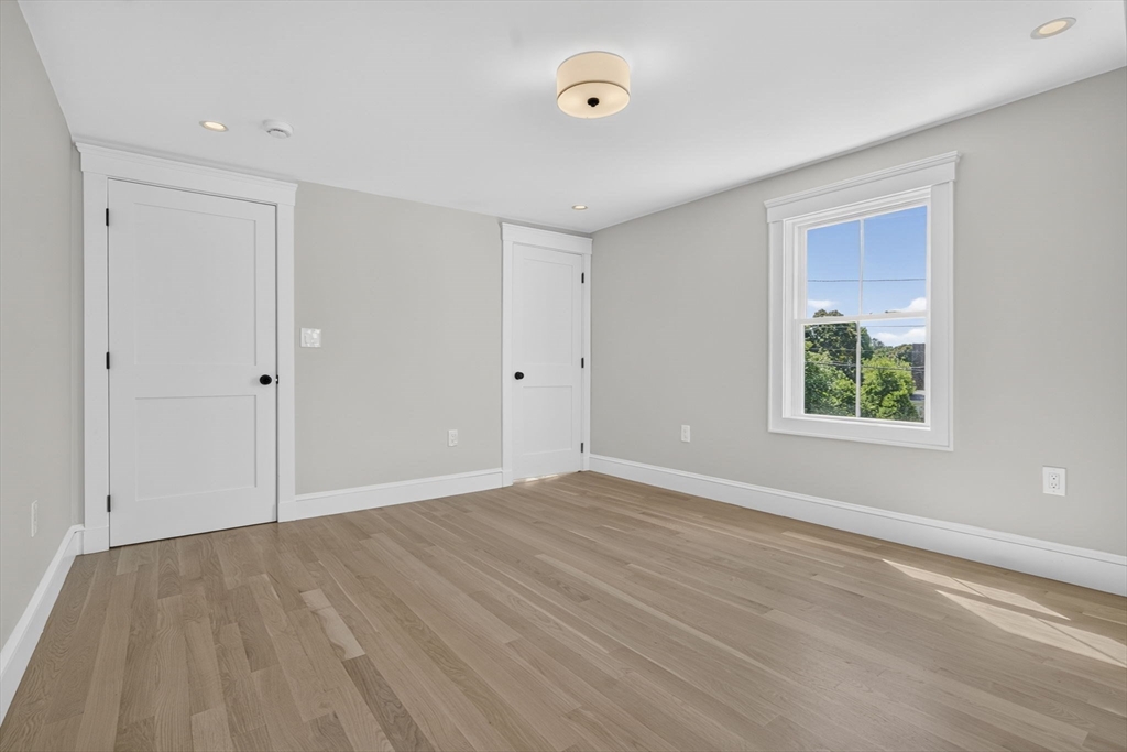 20 Saltonstall Road Medford, MA 02155 - Photo 29 of 41 a view of an empty room with wooden floor and a window