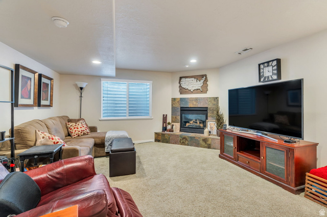 1602 Renaissance Way Springville, UT 84663 - Photo 22 of 42 Carpeted living room featuring a tile fireplace and recessed lighting