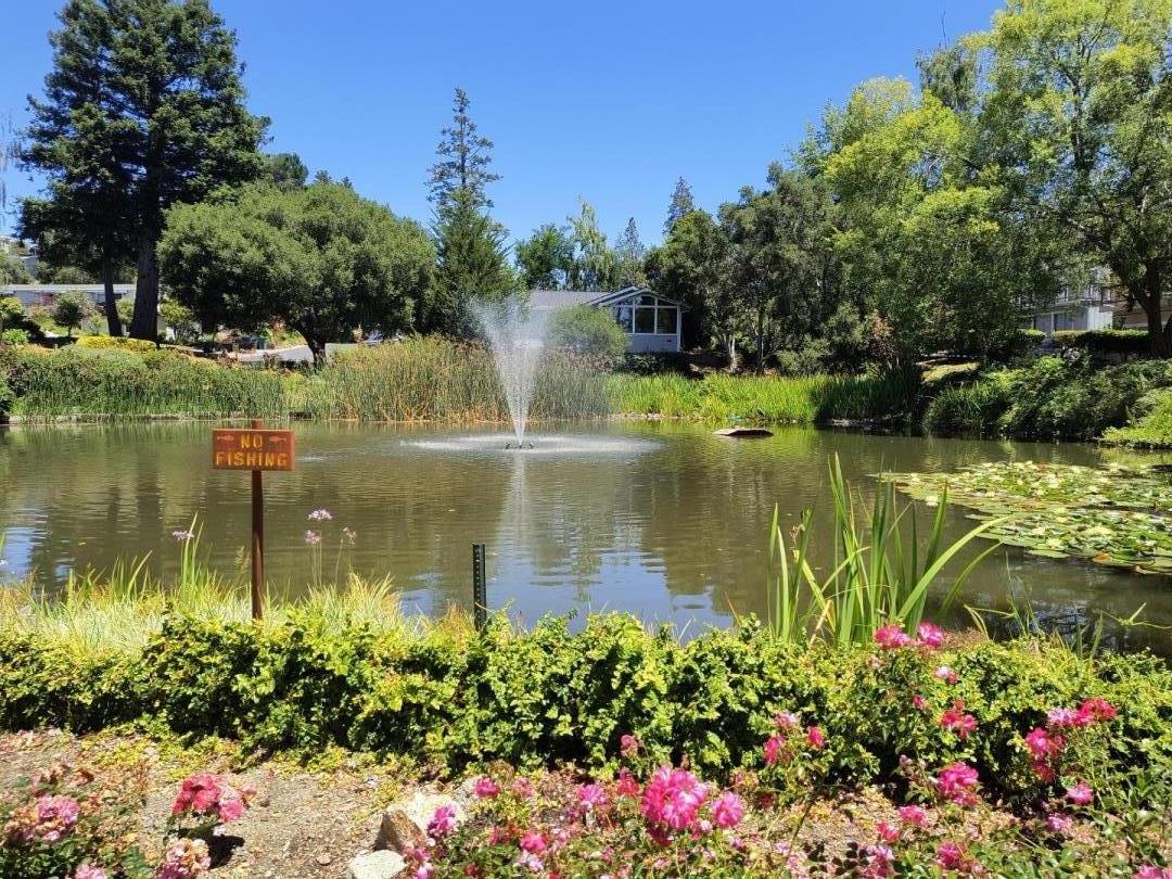 552 Bean Creek Road, Unit 126 Scotts Valley, CA 95066 - Photo 31 of 34 a view of a lake with a house in the background