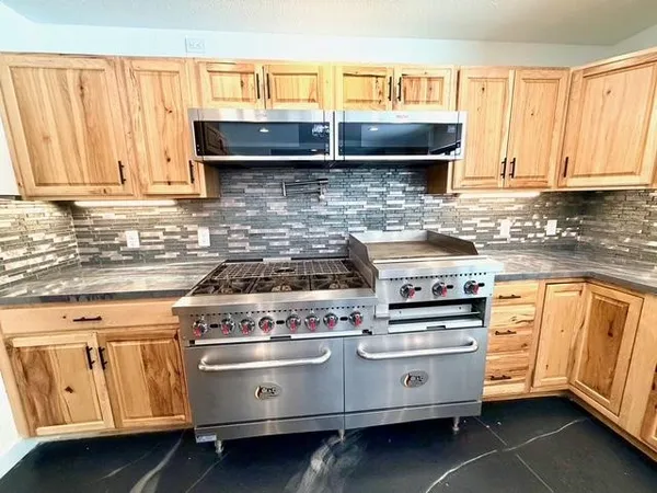 a bathroom with a double vanity sink a mirror and bathtub