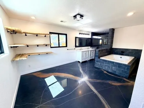 a bathroom with a granite countertop sink toilet a mirror and shower