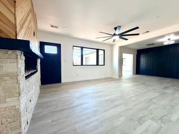 a kitchen with stainless steel appliances kitchen island granite countertop a refrigerator and a stove top oven