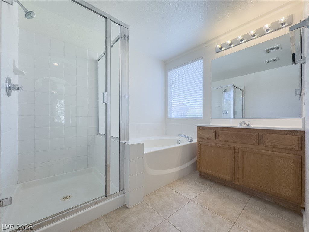9456 Grandview Spring Avenue Las Vegas, NV 89166 - Photo 25 of 49 A well-appointed bath features a spacious glass-enclosed shower and a separate soaking tub.