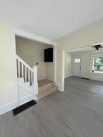 a view of entryway and hall with wooden floor