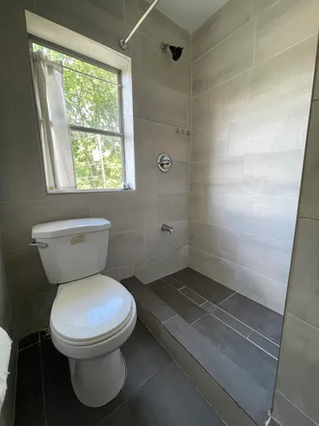 a bathroom with a toilet sink and window