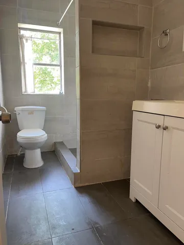 a bathroom with a sink toilet and mirror