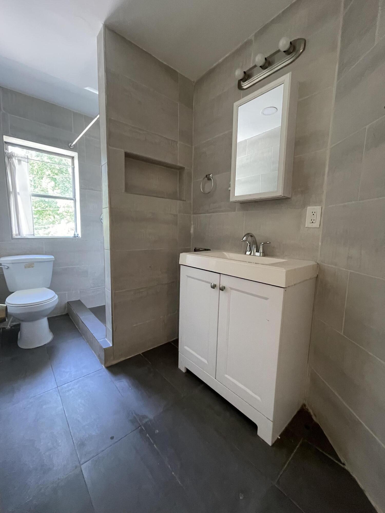 1664 West Main Street Stroudsburg, PA 18360 - Photo 19 of 29 a bathroom with a sink toilet and mirror