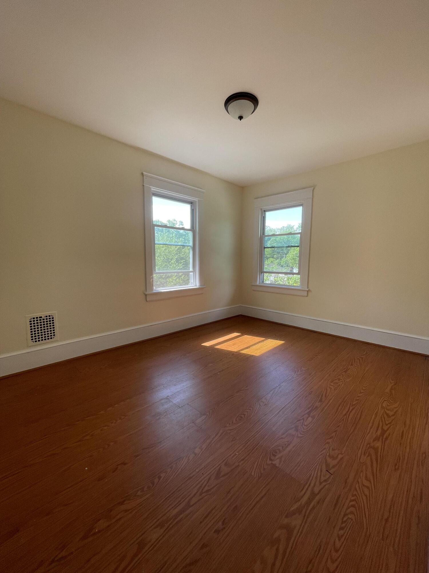 1664 West Main Street Stroudsburg, PA 18360 - Photo 20 of 29 an empty room with wooden floor and windows