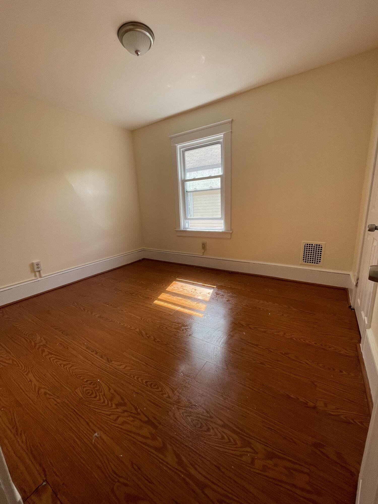 1664 West Main Street Stroudsburg, PA 18360 - Photo 21 of 29 an empty room with wooden floor and windows
