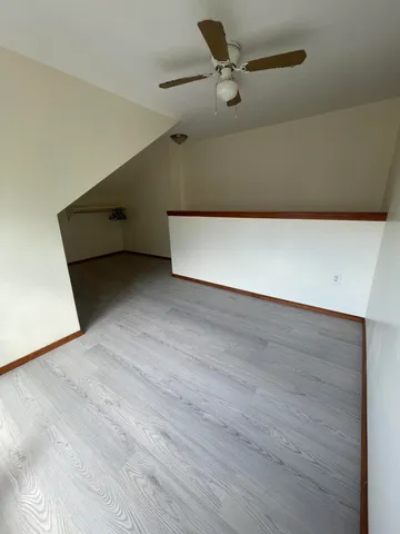 a view of an empty room and kitchen