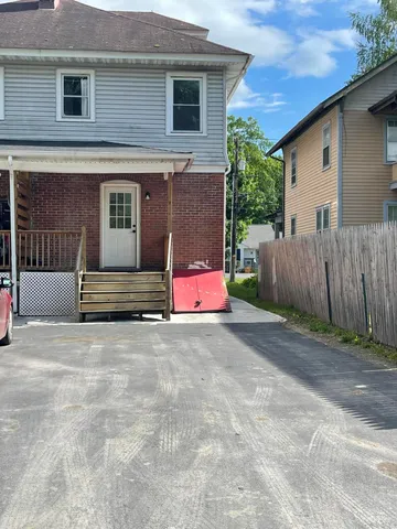 a house that has a tree in front of it