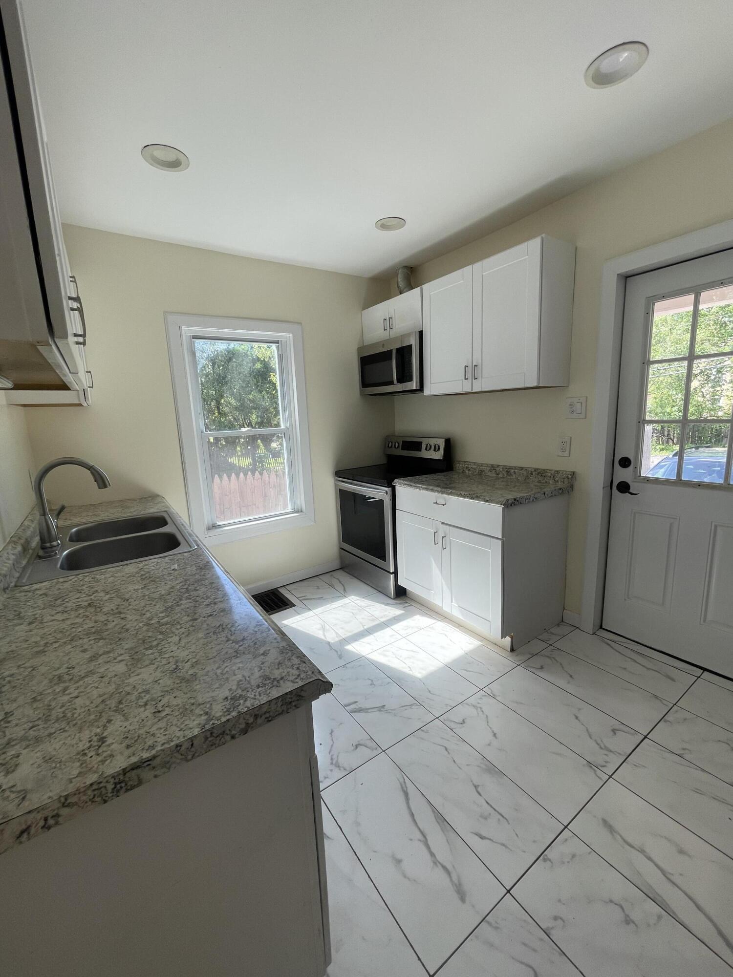 1664 West Main Street Stroudsburg, PA 18360 - Photo 7 of 29 a kitchen with stainless steel appliances granite countertop a sink stove and cabinets