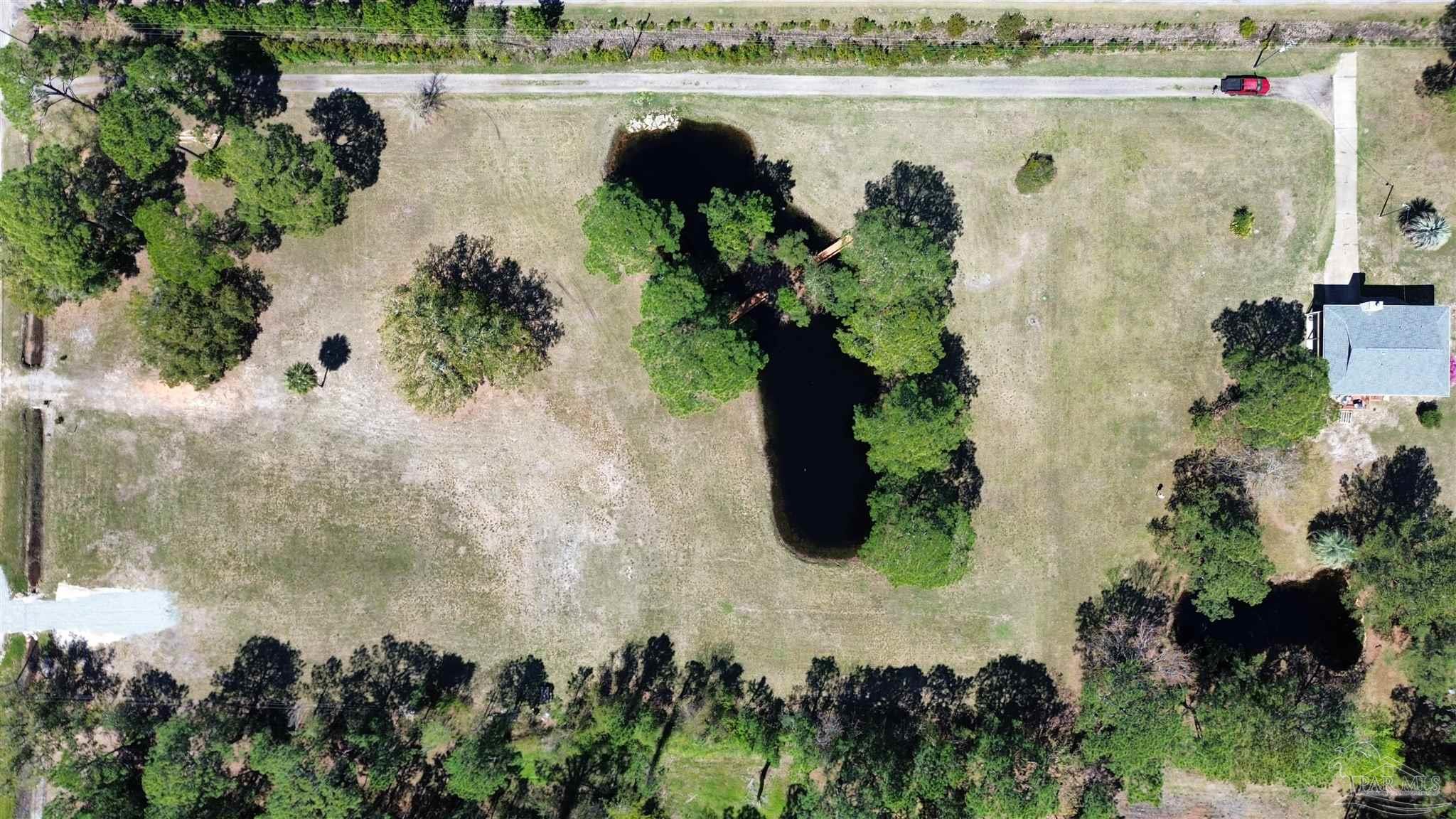 1164 Pearson Road, Unit LOT 2 Milton, FL 32583 - Photo 25 of 25 a view of a lake with a building in the background