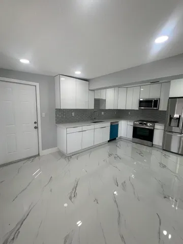 a kitchen with a sink cabinets and appliances